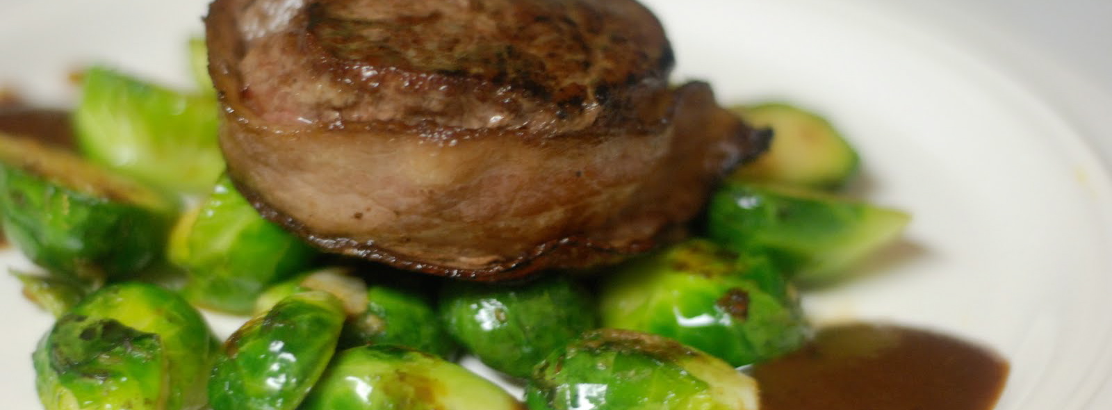 Bacon Wrapped Beef Filet over Sauteed Brussel Sprouts – $1.25